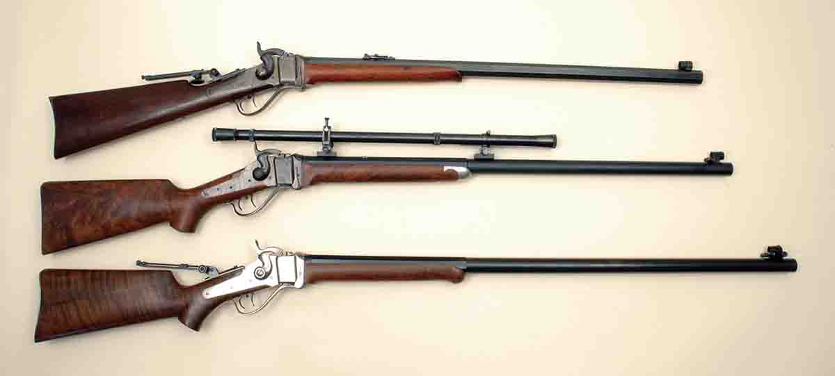 Three Sharps Model 1874s include (top to bottom): an original with a 28-inch  barrel, a Shiloh Rifle Manufacturing rifle with an MVA 6x scope and 30-inch barrel and a C. Sharps Arms version with a 32-inch barrel.